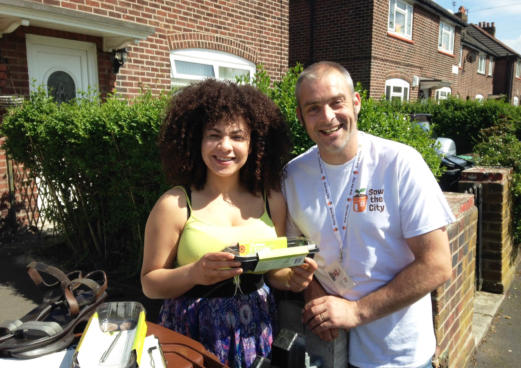 two people pose for camera as part of south manchester neighbourhood food project