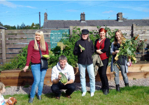 community growing group in Bolton with harvested vegetables they have grown